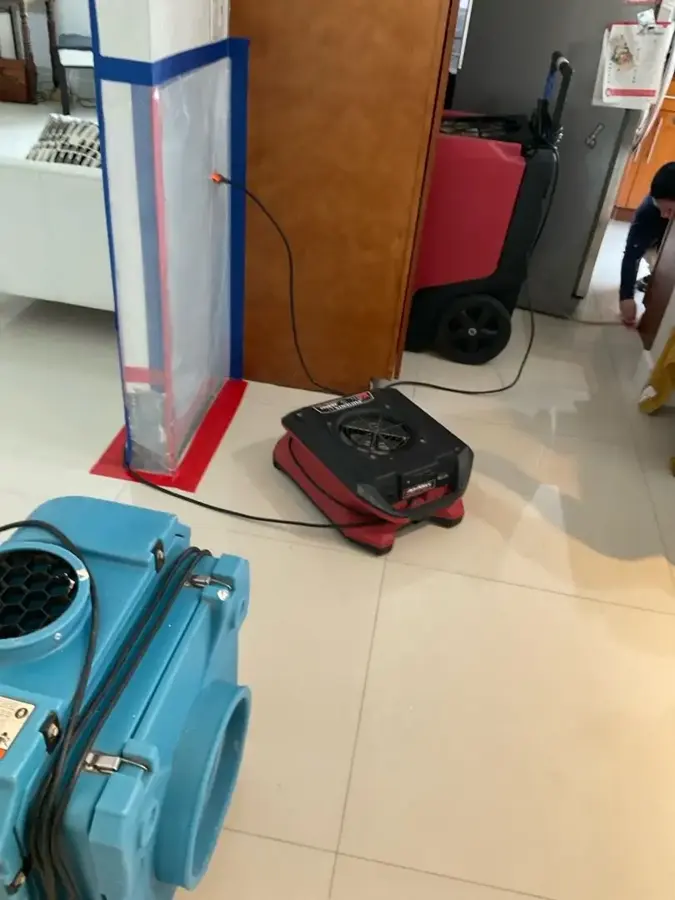A dehumidifier and air mover drying a room in a Hawthorne, CA property